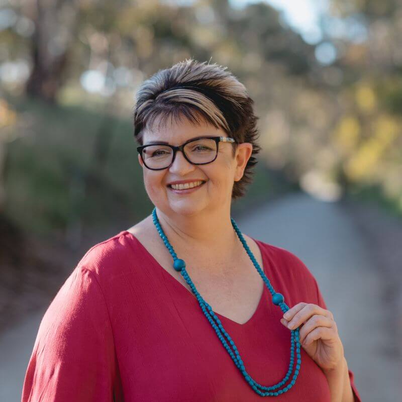 a woman wearing a red shirt and glasses